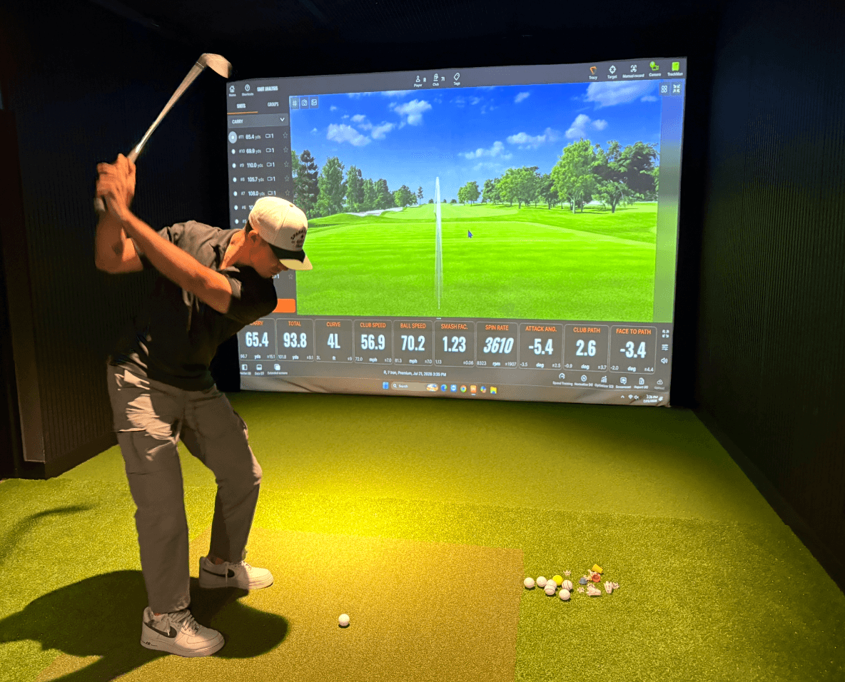 A golfer using a TrackMan simulator bay at Sparks Golf